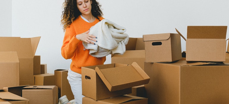 woman packing because she is moving out for the first time