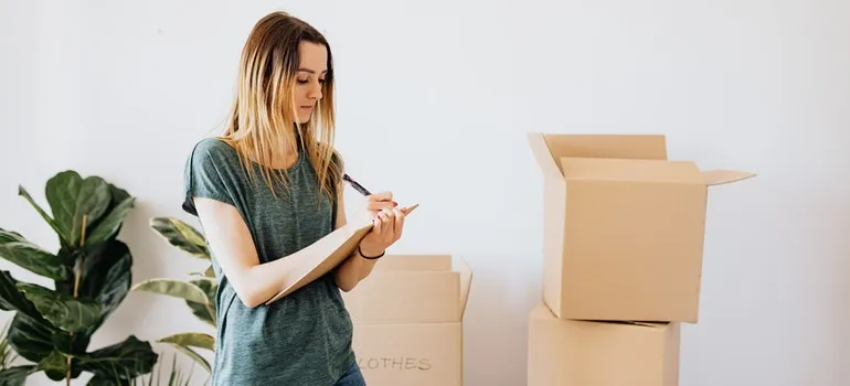 person writing down what goes to storage
