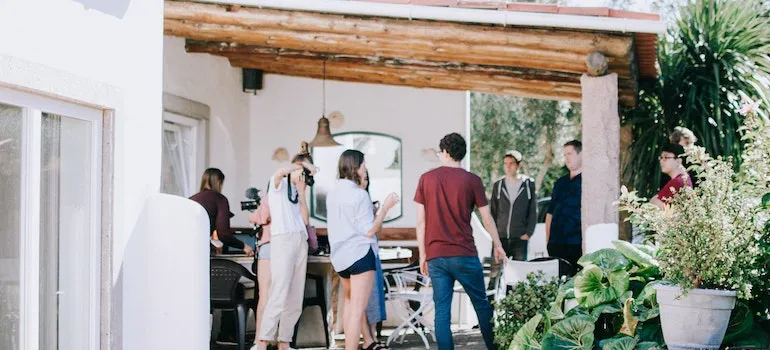 friends on a porch making barbique after moving out of the city