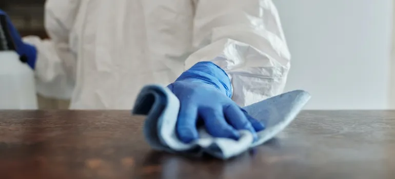 person cleaning their table