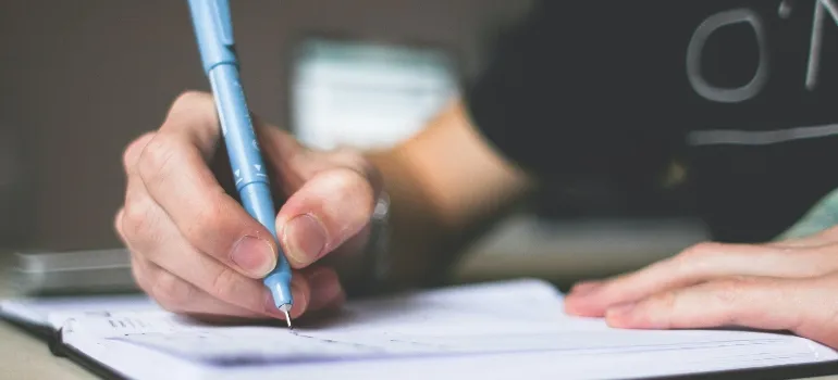 person writing something in their notebook