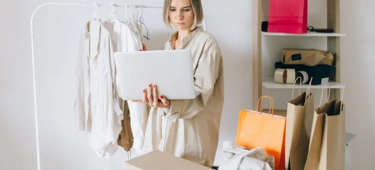 women deciding should she hang or fold clothes