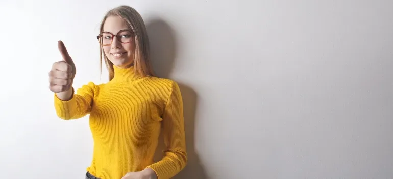 smiling woman in yellow turtlenek