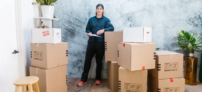 smiling guy monitoring moving boxes and talking about the most affordable cities in Idaho 