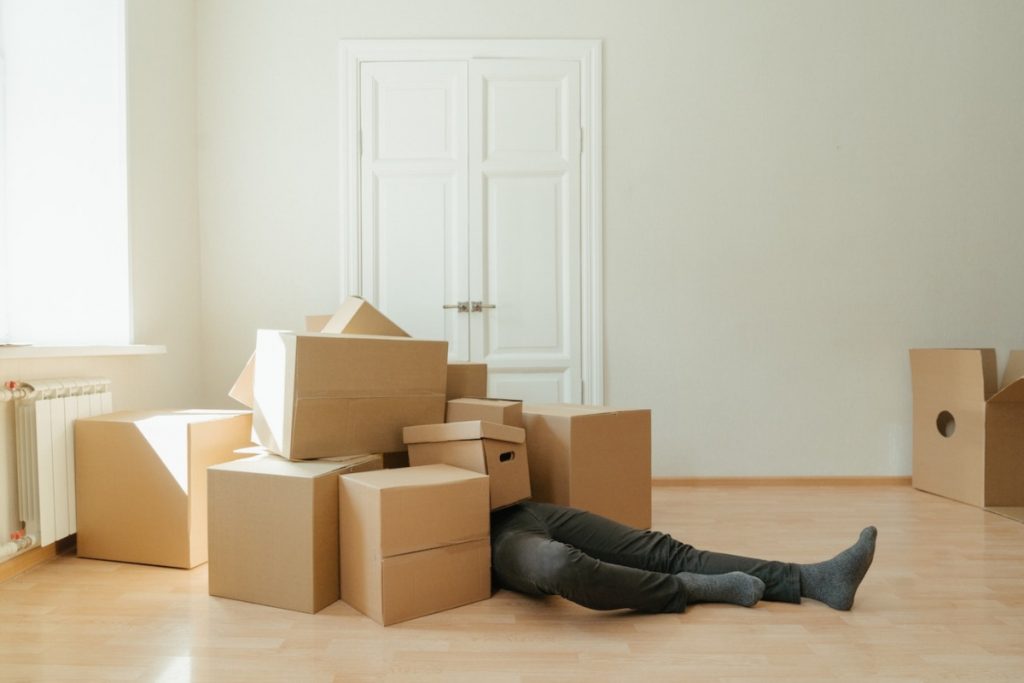 a man stuck among moving boxes