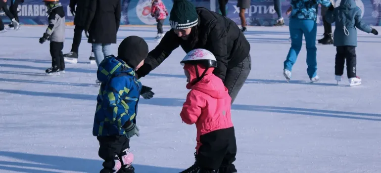 a woman teaching her kids to ice skate after their move to Star