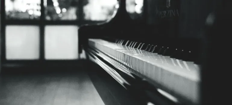 black and white photo of a difficult to move piano