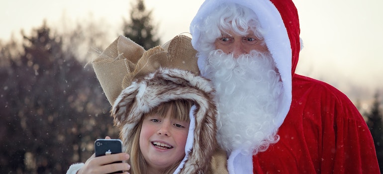 Santa Claus and a child taking a picture
