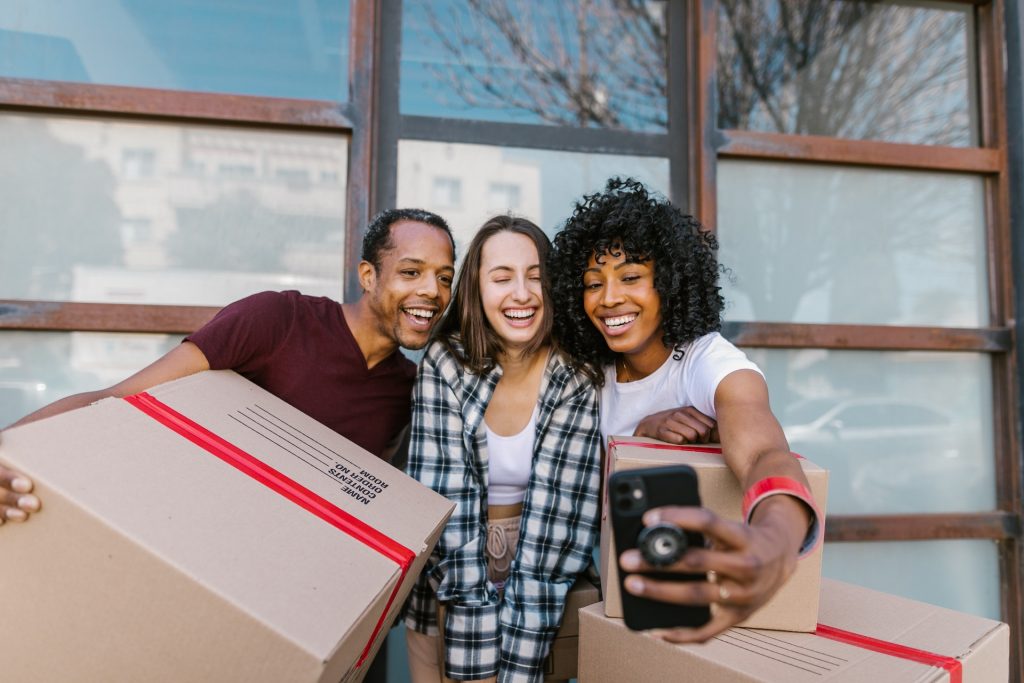 people with boxes happy about moving