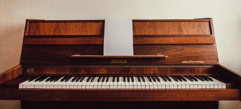 brown piano in a room