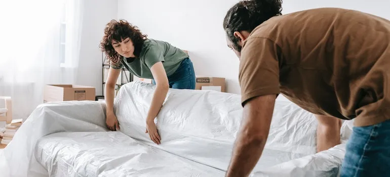 a couple is protecting a couch