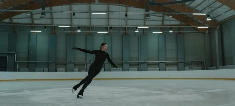 A woman in the ice rink skating