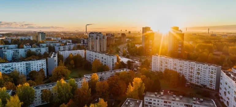 A sun shining over buildings symbolizing reasons families decide to move