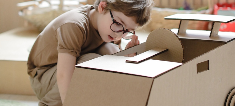 a boy playing with a box