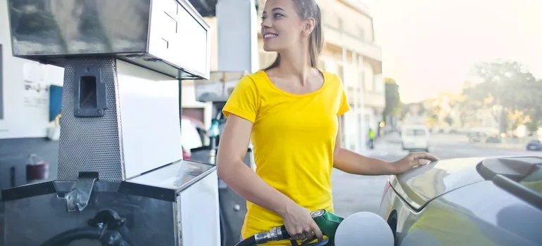 a woman pumping gas