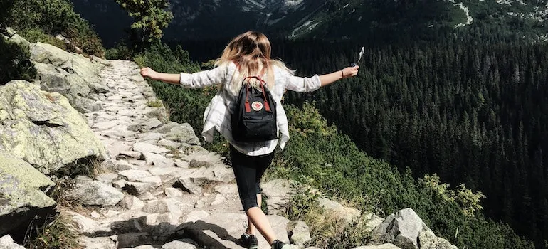 Woman Standing on Cliff