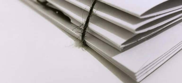 documentation wrapped with a piece of string needed for packing and shipping medical equipment