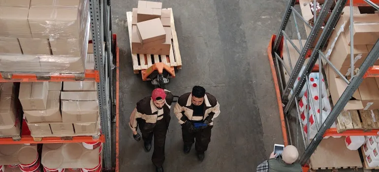 Two men in a storage facility are experts for industrial storage and its uses