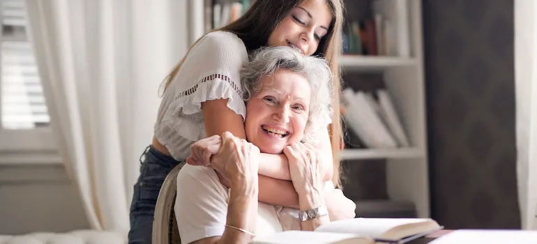 Daugther hugging mom and giving moving advice for people with disabilities