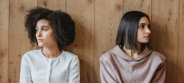 two upset women looking away from each other