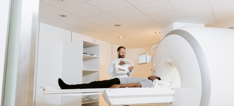 a person and a doctor in front of a MRI machine