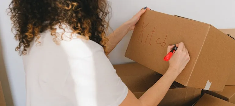 a woman labeling a box
