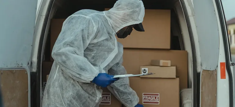 a medical shipping employee checking boxes and their labels