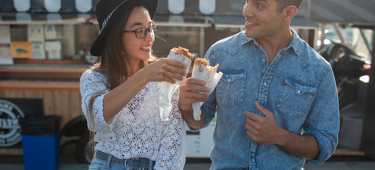 A man and a woman eating and discussing the facts about Boise suburbs