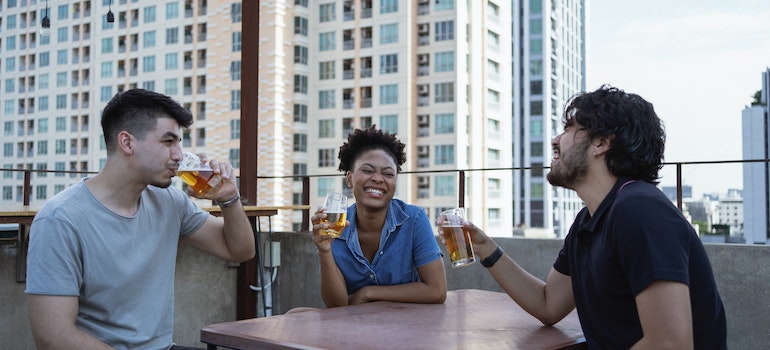 A group of friends drinking beer and laughing about facts about Boise suburbs