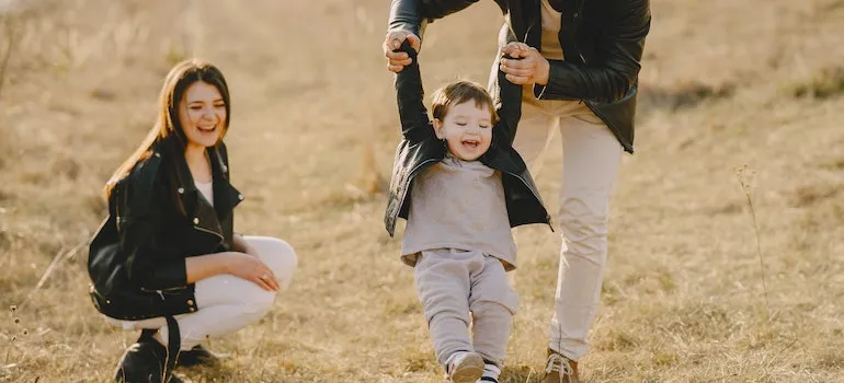 A family playing with their kid outside sharing facts about Boise suburbs