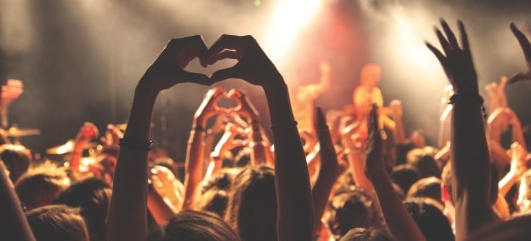 Hands in the air showing a heart sign