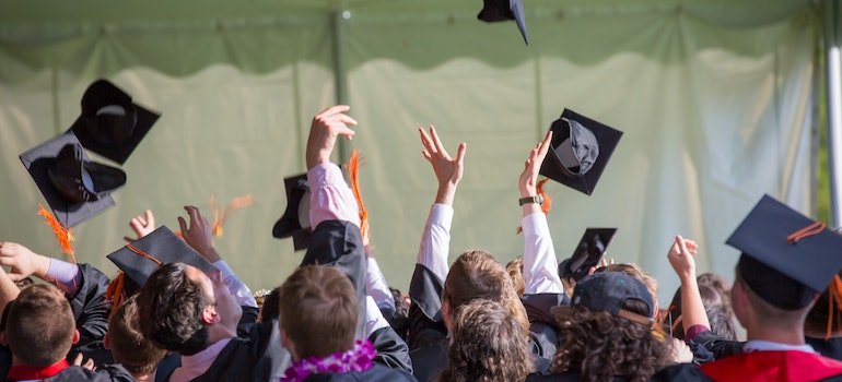 students throwing graduation caps