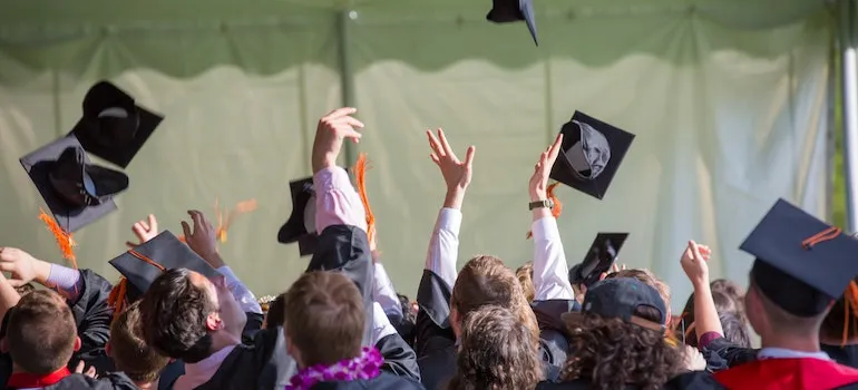 students throwing graduation caps