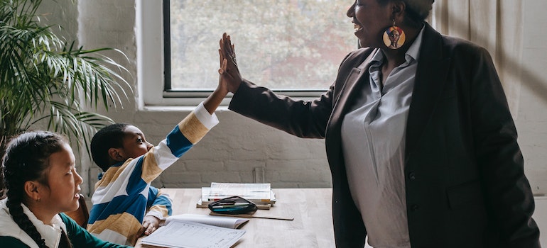 a teach high fiving a student