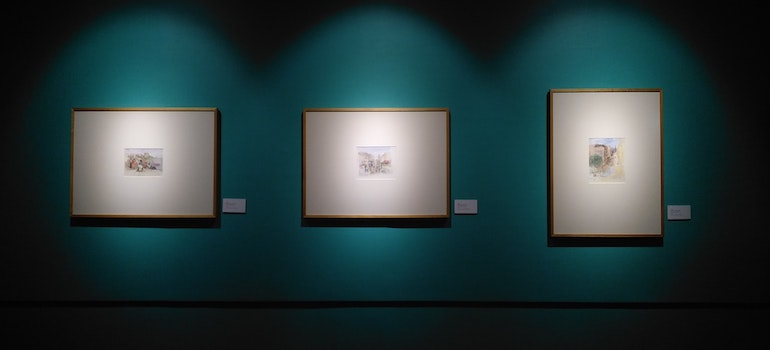 three paintings on a wall