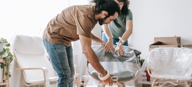 Man and woman setting up furniture and discussing techniques for finding calm in your new Boise home
