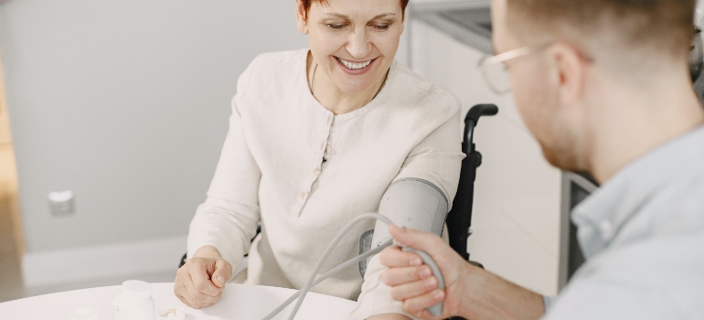 A doctor measuring the blood pressure of a woman