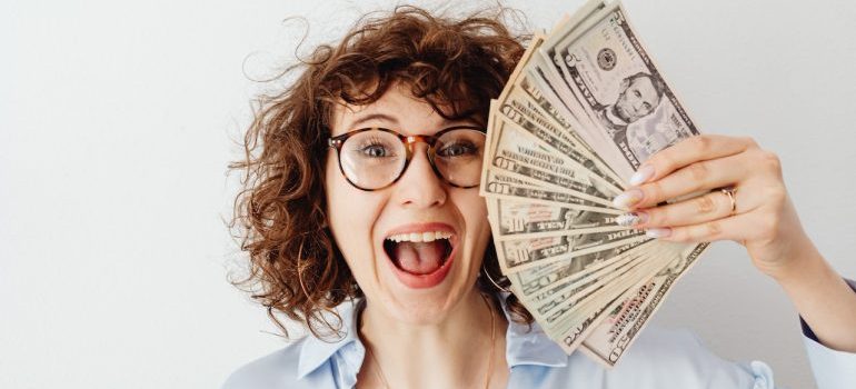 a woman having saved money after considering all the things to watch out for when booking Idaho movers