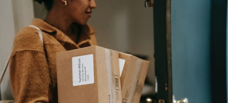 a woman moving after having considered all the things to watch out for when booking Idaho movers