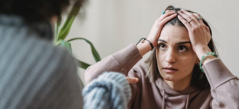 a woman worried about the things to watch out for when booking Idaho movers