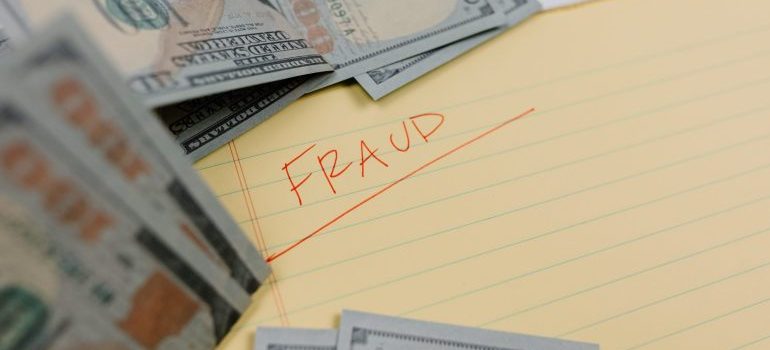 the word ''fraud'' written on a piece of paper