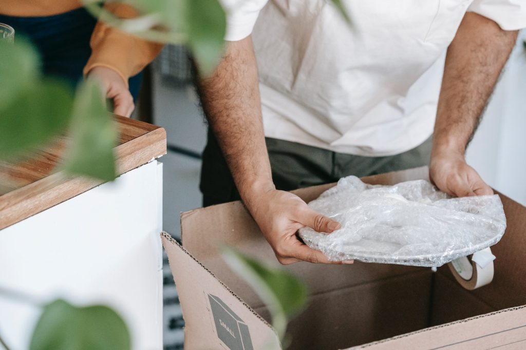 A man getting a Wrapped Plate from a Box