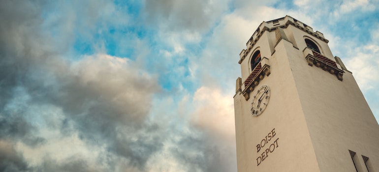 Exterior of Boise depot clock tower against cloudy blue sky