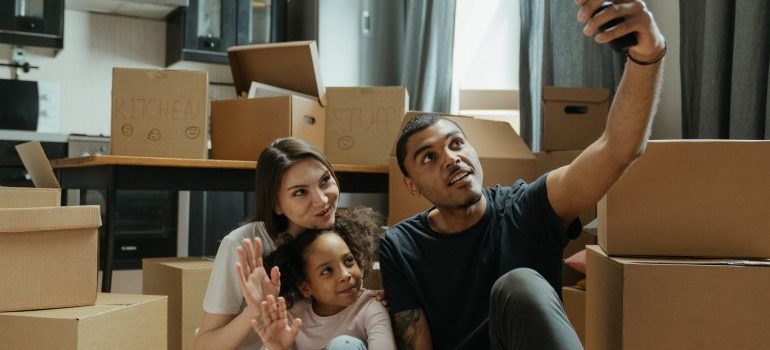 Family taking a selfie after hiring a full-service moving company