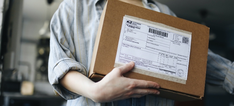 Person managing their subscriptions and mail during a move