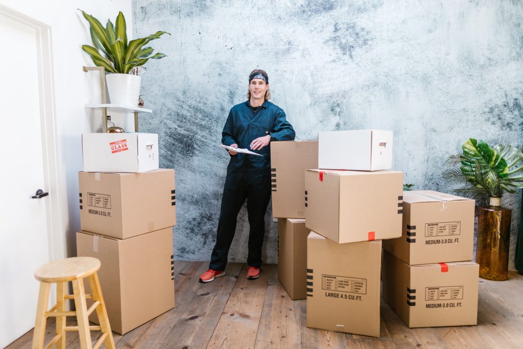 Moving professional standing next to boxes