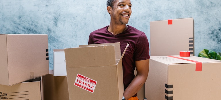 A man holding a brown box