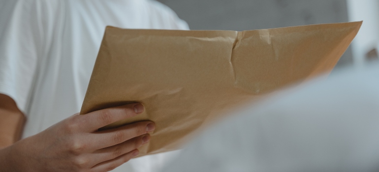 Person managing their subscriptions and mail during a move