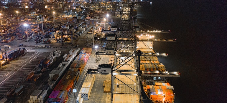 A harbor with containers at night ready for door to door shipping international