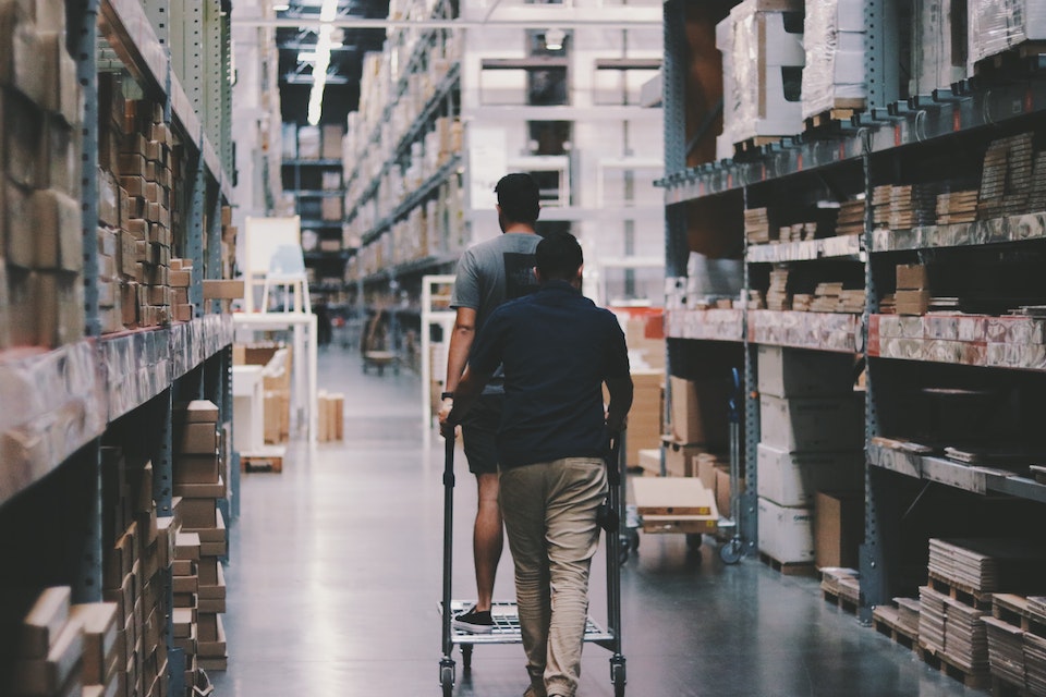 A couple in a warehouse as they choose the right business storage option